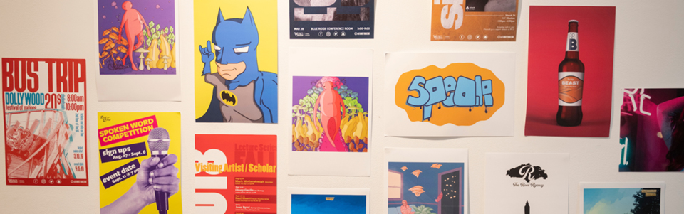different works by students in the graphic design program hanging in a gallery