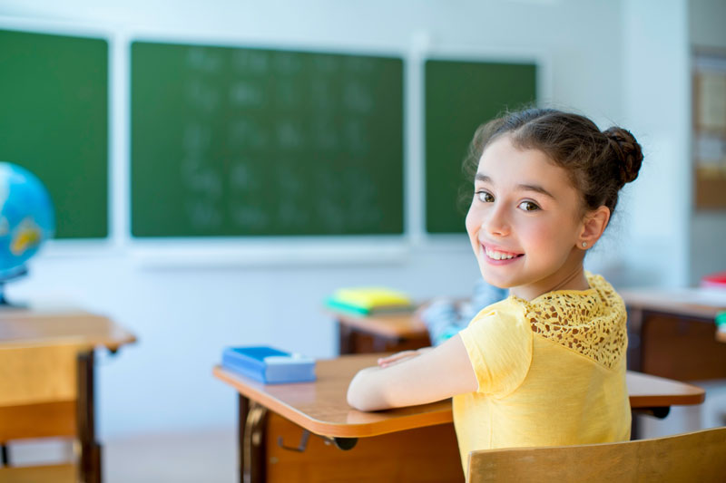 Young girl at desk in classroom