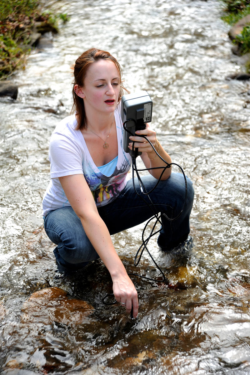 Environmental Health Student conducting research in a creek