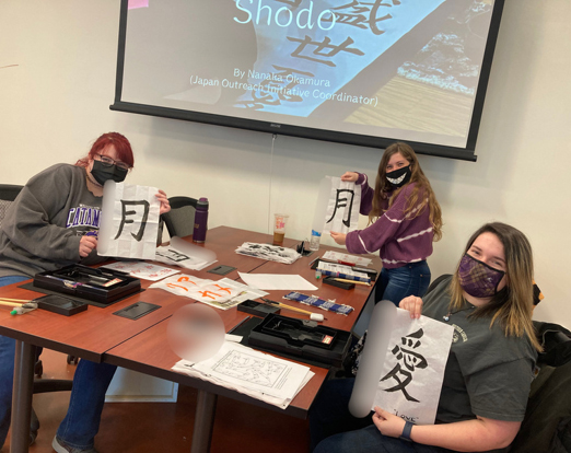 students who practicing Japanese calligraphy